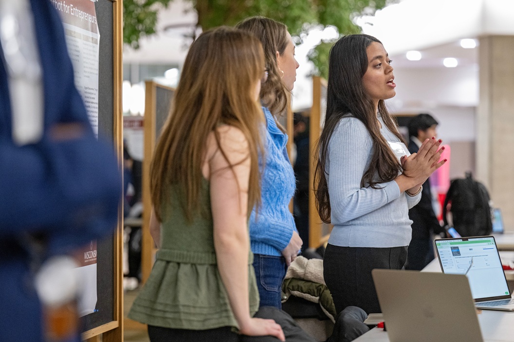 Devanshi Jain (far right) leads the discussion with her teammates, McKenzie Kujava, left, and Trinity Krohn, center, during the Tech Exploration Lab Demo Night on Wednesday, December 3, 2025, at the Wisconsin School of Discovery. (Paul L. Newby II / UW-Madison Wisconsin School of Business)