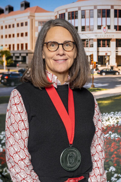 Erica Kauten Director of the Wisconsin SBDC at UW-Madison, Michelle Somes-Booher wears the medal she received at the WSB investiture ceremony. 
